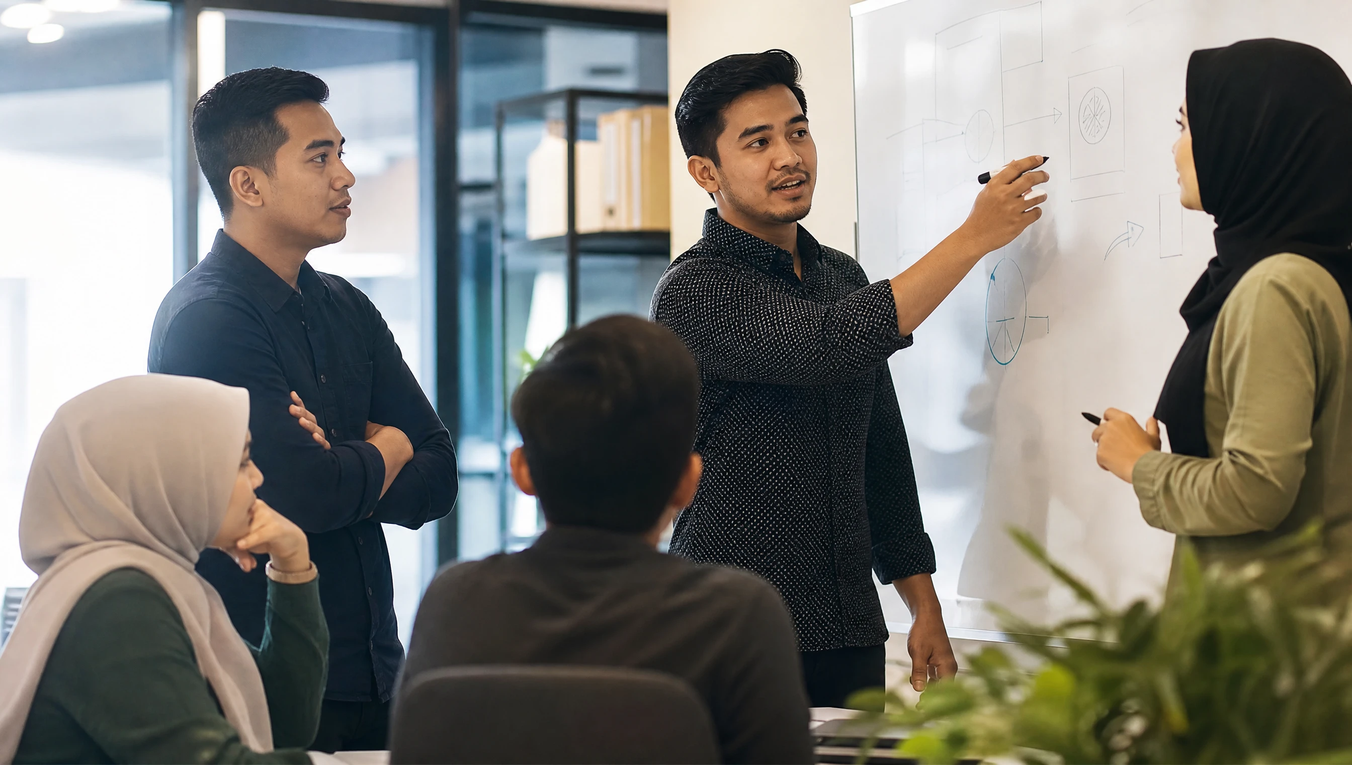 Pasukan digital Malaysia berbincang di papan putih merancang strategi pemulihan SEO di pejabat moden