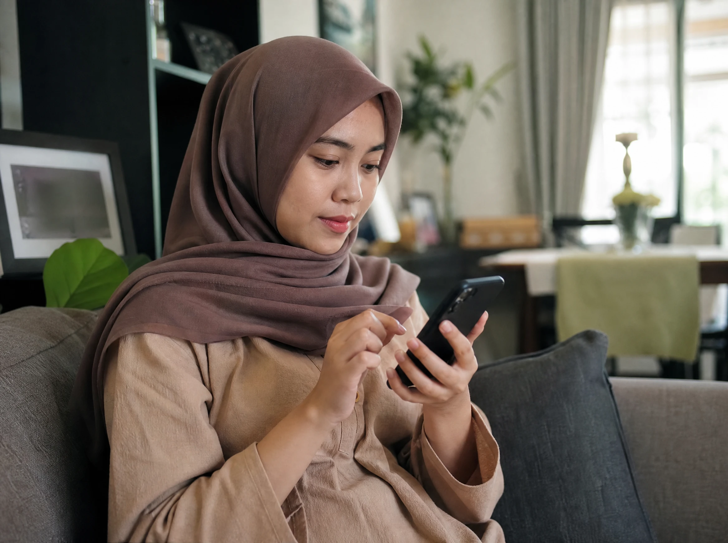 Malaysian woman booking an appointment on a mobile app