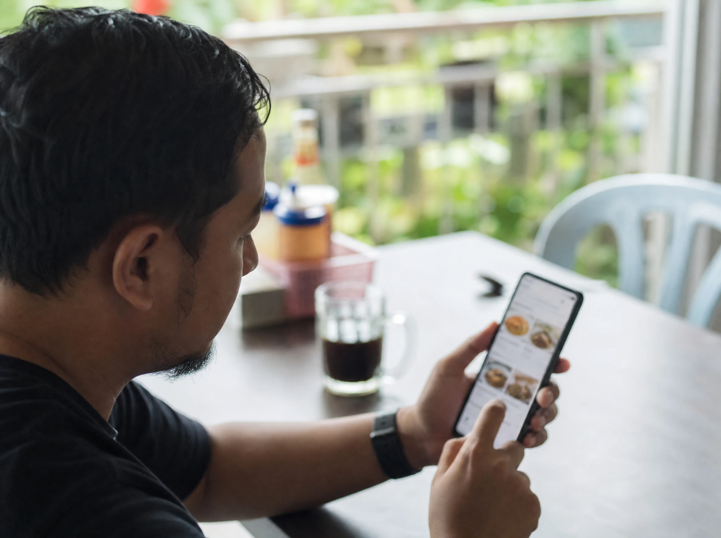 Malaysian man ordering food on a delivery app