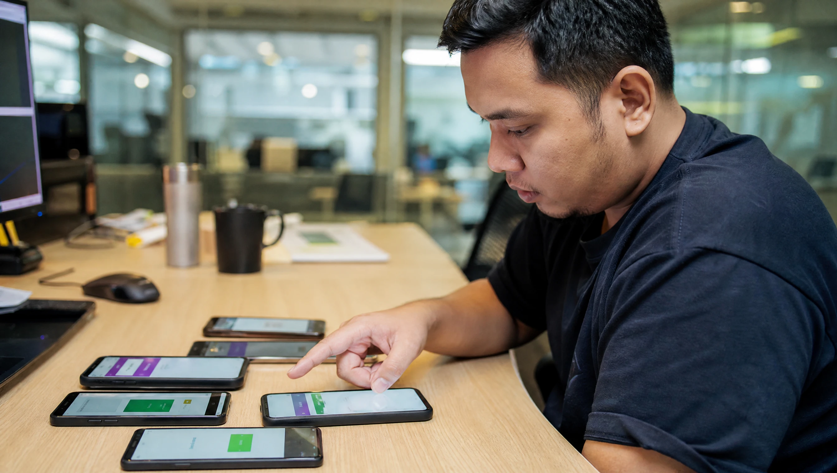 Developer testing an app on several real phones