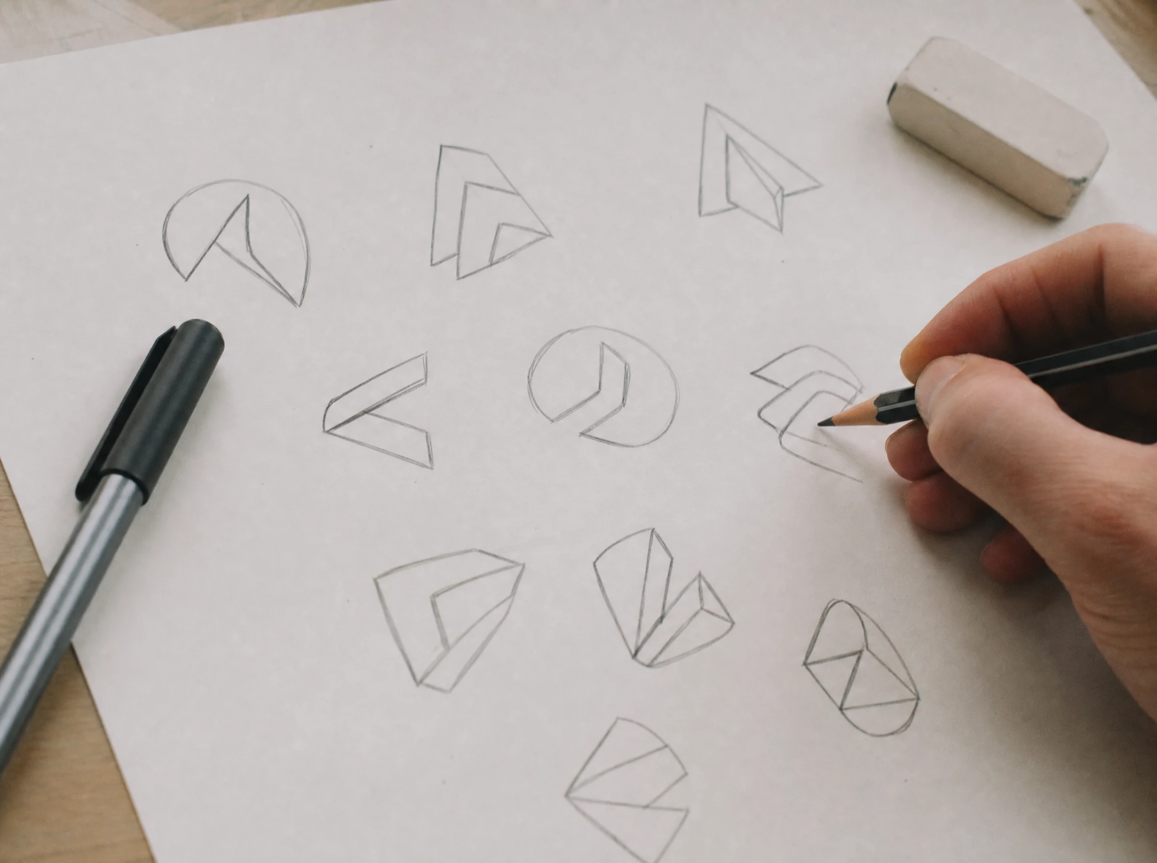 Hand sketching abstract logo concept variations on paper