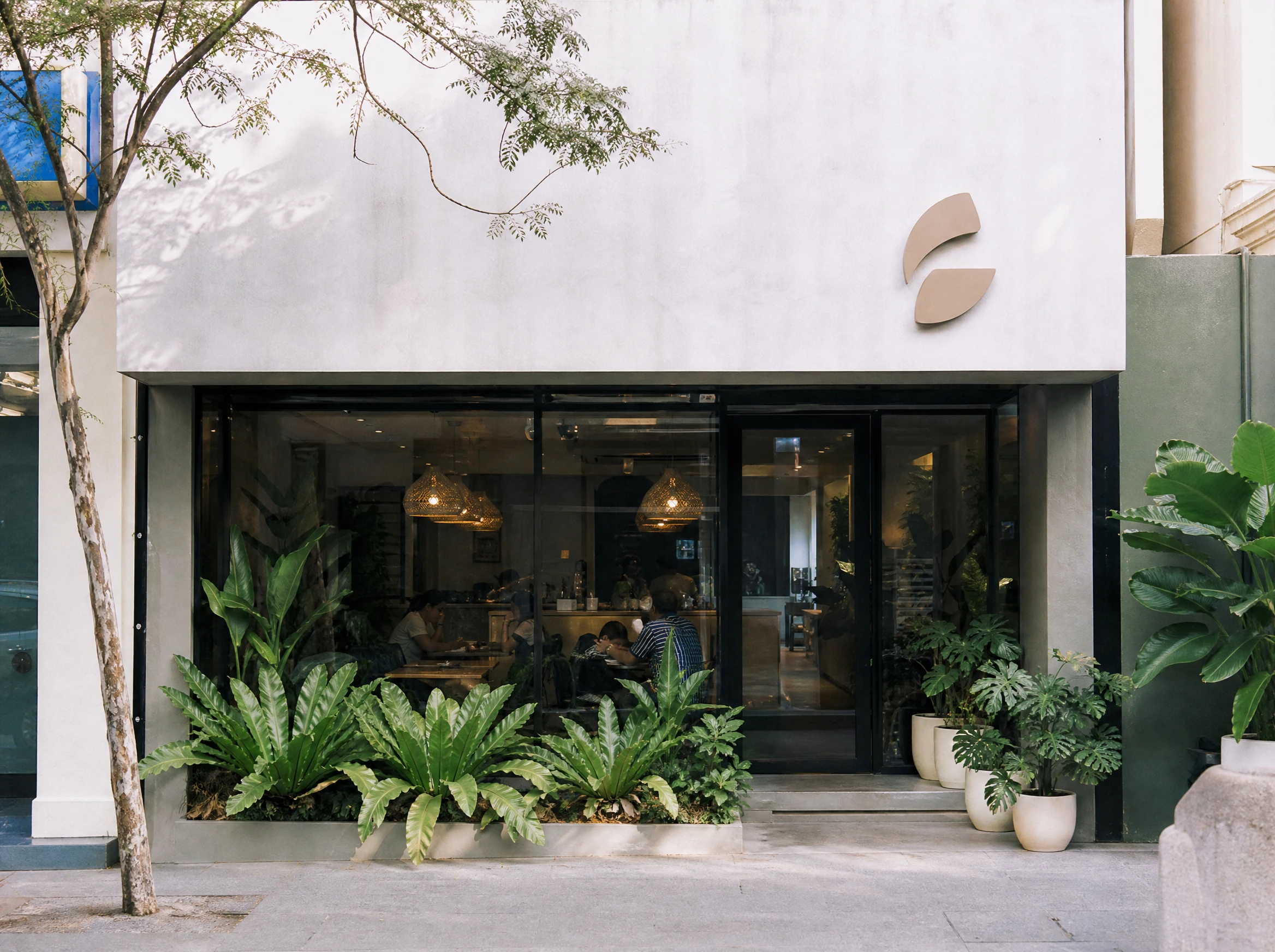 Modern Malaysian cafe shopfront with a minimal brand sign