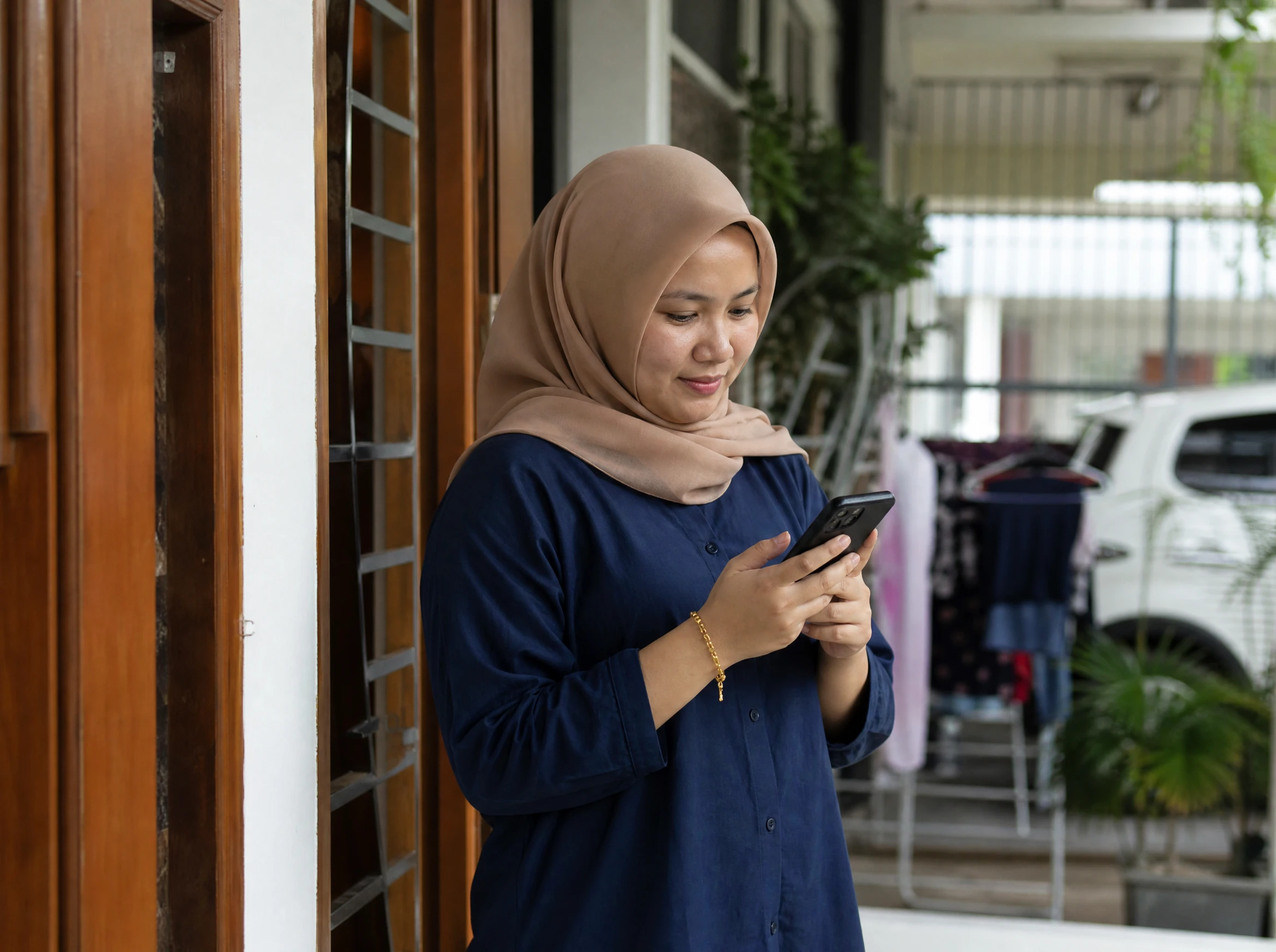 Malaysian woman tracking her delivery order on a phone app