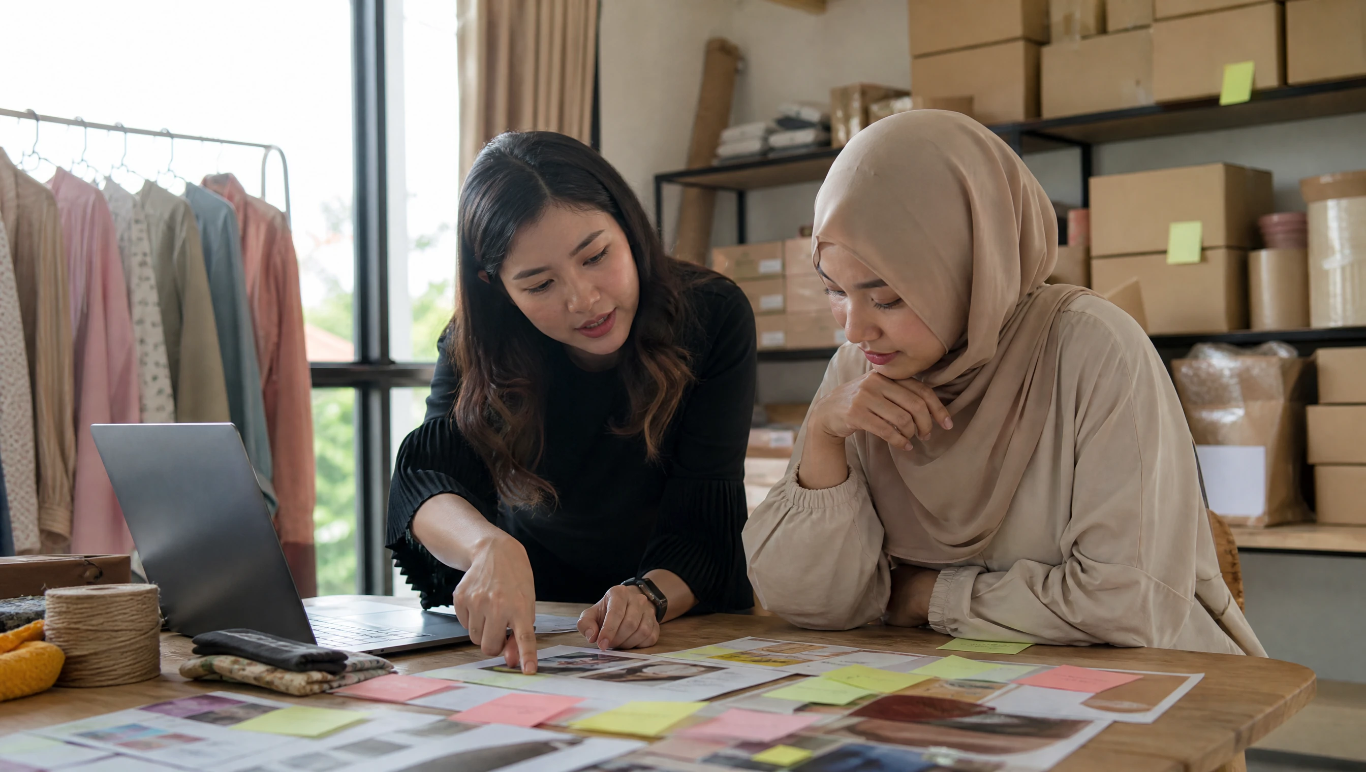 Malaysian designer and store owner planning a product catalog together