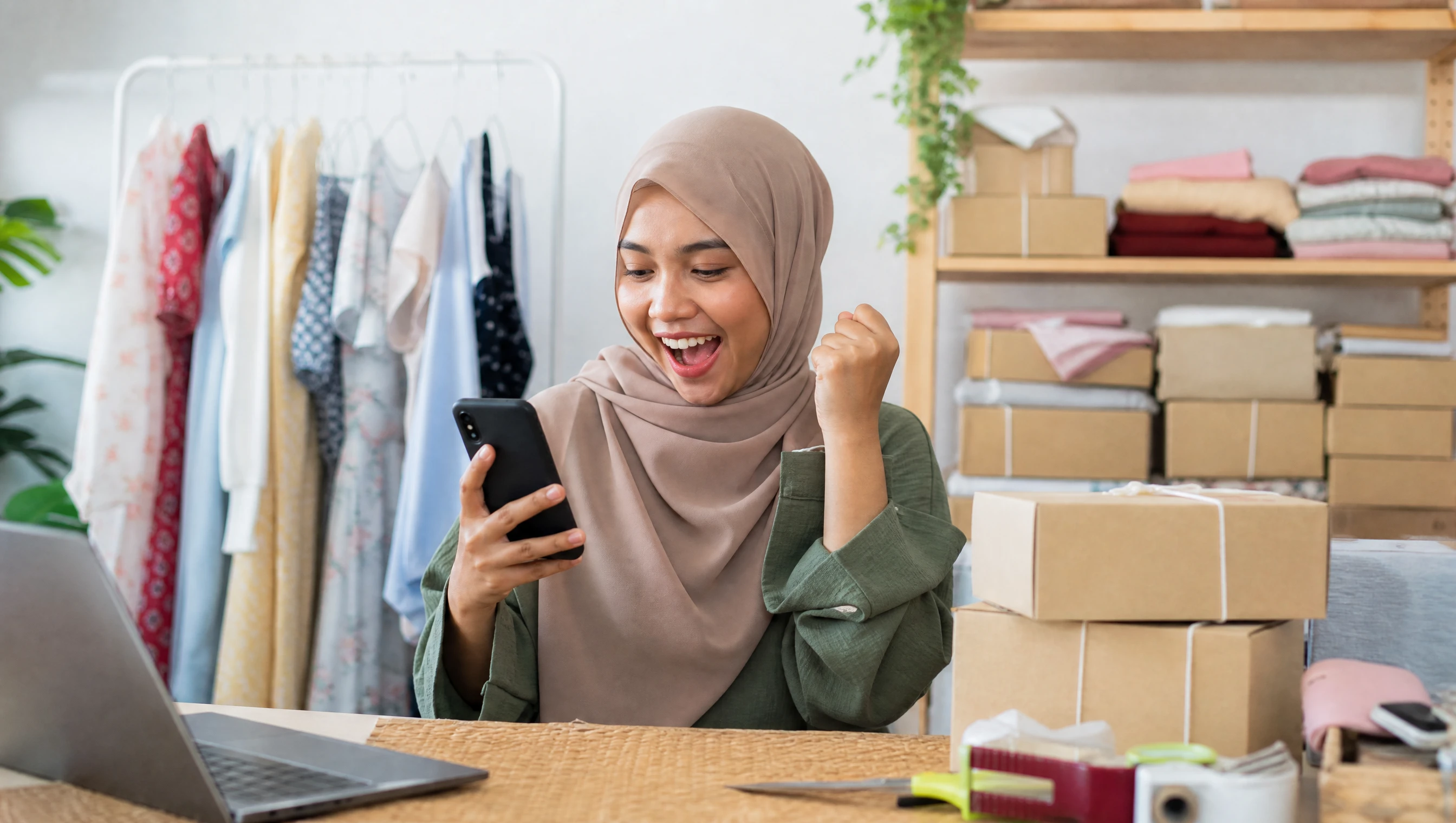 Happy Malaysian store owner celebrating her first online sale